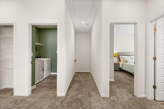 hallway with carpet floors and washing machine and clothes dryer