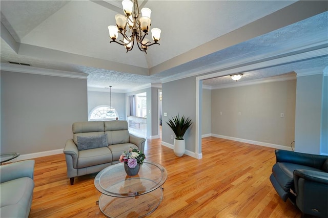 3265 Bethesda Park Ct, Lawrenceville, GA 30044 - living area with a tray ceiling, a chandelier, baseboards, light wood-type flooring, and crown molding