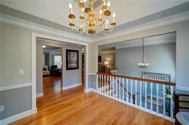 3265 Bethesda Park Ct, Lawrenceville, GA 30044 - hallway featuring a chandelier, an upstairs landing, light wood finished floors, ornamental molding, and baseboards