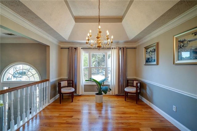 3265 Bethesda Park Ct, Lawrenceville, GA 30044 - sitting room featuring a chandelier, healthy amount of natural light, a raised ceiling, light wood-style flooring, and a textured ceiling