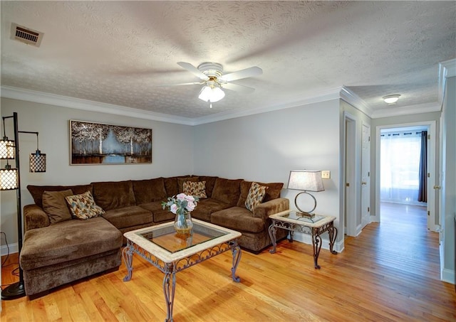 3265 Bethesda Park Ct, Lawrenceville, GA 30044 - living room featuring light wood finished floors, ceiling fan, a textured ceiling, baseboards, and crown molding