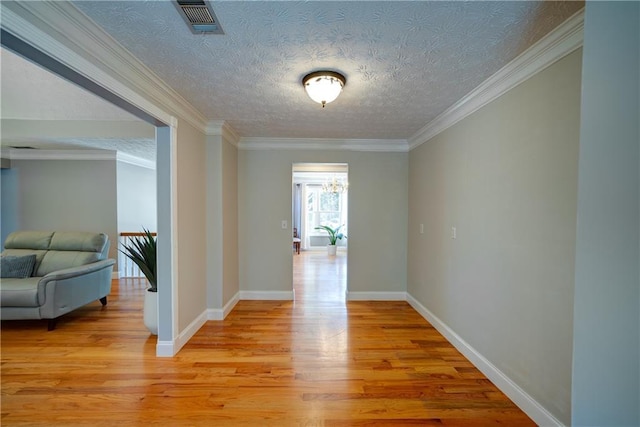 3265 Bethesda Park Ct, Lawrenceville, GA 30044 - hallway with light wood-style flooring, a chandelier, ornamental molding, baseboards, and a textured ceiling