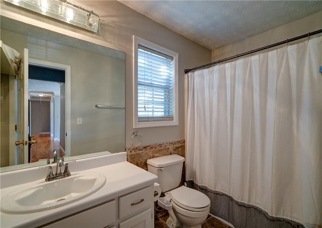 3265 Bethesda Park Ct, Lawrenceville, GA 30044 - bathroom with tile walls, toilet, wainscoting, vanity, and a textured ceiling