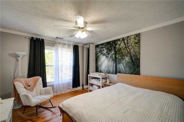 3265 Bethesda Park Ct, Lawrenceville, GA 30044 - bedroom with wood finished floors, ornamental molding, ceiling fan, and a textured ceiling