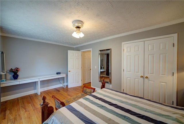 3265 Bethesda Park Ct, Lawrenceville, GA 30044 - bedroom featuring light wood-style flooring, a closet, ornamental molding, baseboards, and a textured ceiling