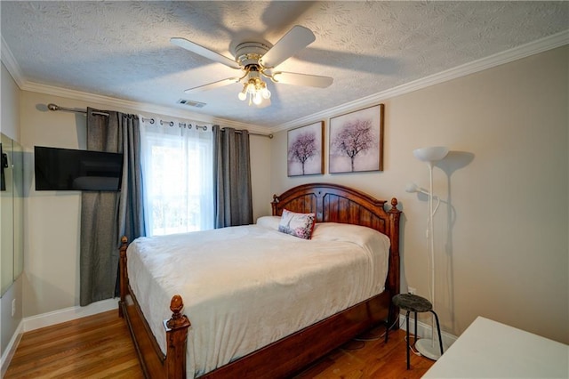 3265 Bethesda Park Ct, Lawrenceville, GA 30044 - bedroom featuring wood finished floors, baseboards, a textured ceiling, ornamental molding, and a ceiling fan