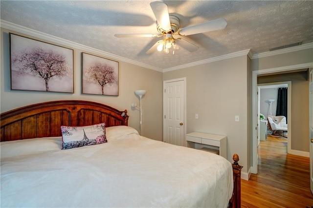 3265 Bethesda Park Ct, Lawrenceville, GA 30044 - bedroom with wood finished floors, ceiling fan, baseboards, a textured ceiling, and crown molding