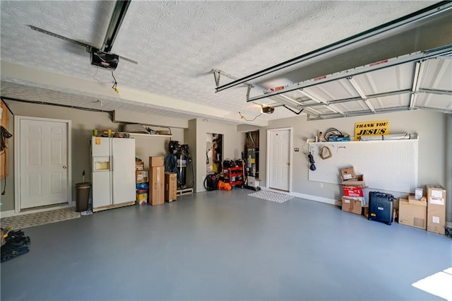 3265 Bethesda Park Ct, Lawrenceville, GA 30044 - garage with white refrigerator with ice dispenser, a garage door opener, and baseboards