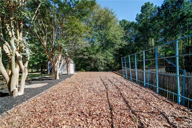 3265 Bethesda Park Ct, Lawrenceville, GA 30044 - view of yard featuring fence, an outbuilding, and a shed
