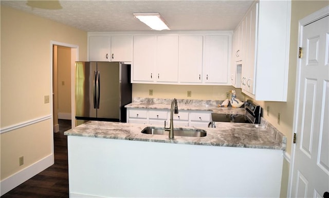 1521 Larkwood Dr, Canton, GA 30114 - kitchen with range with electric stovetop, a sink, freestanding refrigerator, a peninsula, and light stone countertops