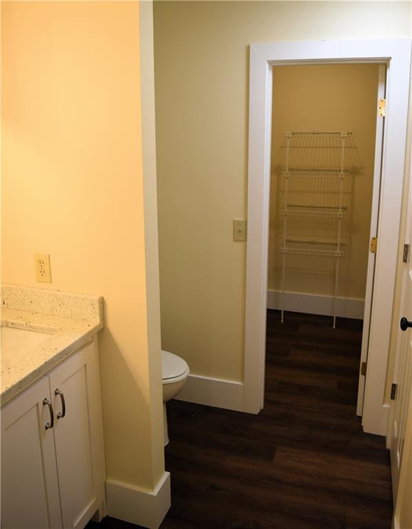 1521 Larkwood Dr, Canton, GA 30114 - bathroom with toilet, wood finished floors, vanity, and baseboards