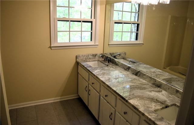 1521 Larkwood Dr, Canton, GA 30114 - bathroom with double vanity, a sink, tile patterned flooring, and baseboards