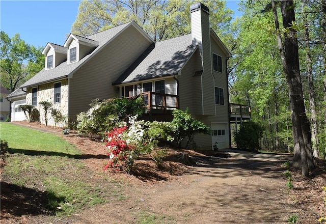 1521 Larkwood Dr, Canton, GA 30114 - view of property exterior with a chimney, driveway, a garage, and a wooden deck