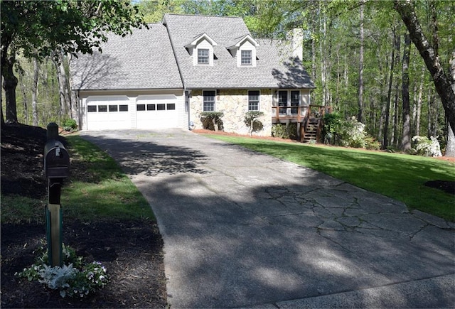 1521 Larkwood Dr, Canton, GA 30114 - new england style home with a front yard, stone siding, an attached garage, a shingled roof, and driveway