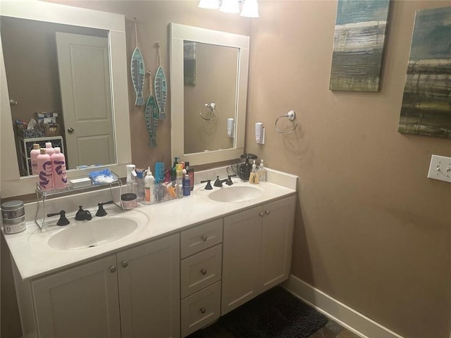 bathroom featuring a sink and double vanity