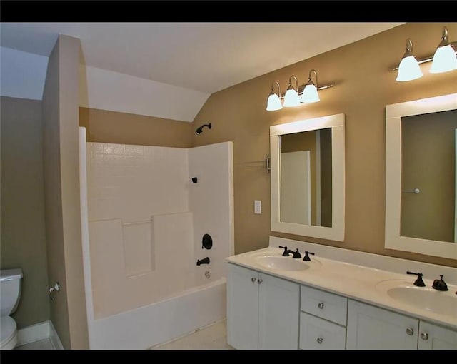 bathroom featuring a sink, washtub / shower combination, toilet, and double vanity