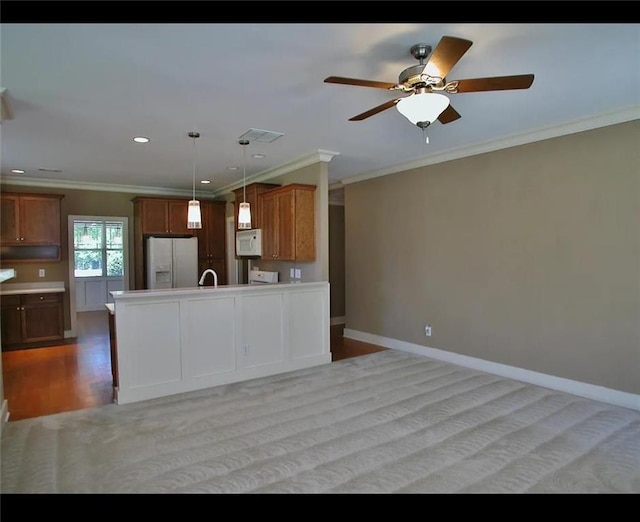 kitchen featuring visible vents, open floor plan, ceiling fan, white appliances, and brown cabinets