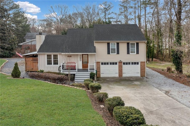 split level home featuring a garage, driveway, a chimney, and a front lawn