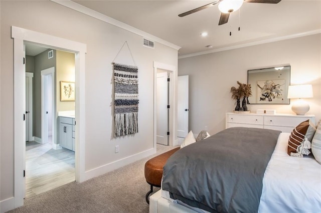 carpeted bedroom featuring ceiling fan, ensuite bath, and ornamental molding