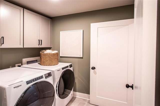 washroom featuring cabinets and washer and dryer