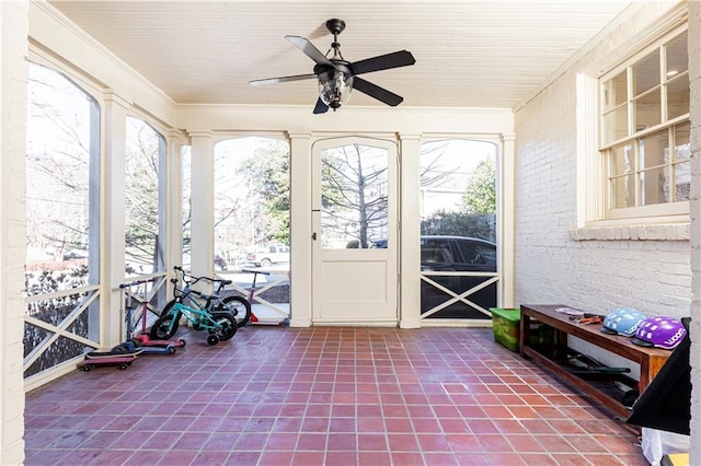 sunroom / solarium with plenty of natural light and ceiling fan