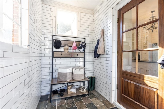 mudroom with tile walls and stone finish floor