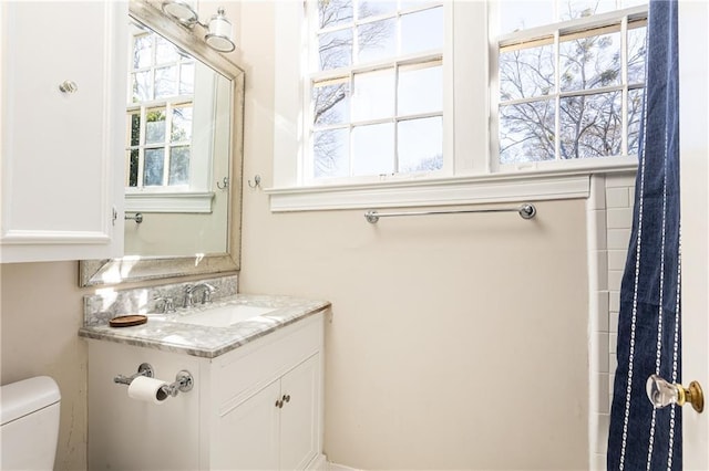 full bath featuring toilet and vanity