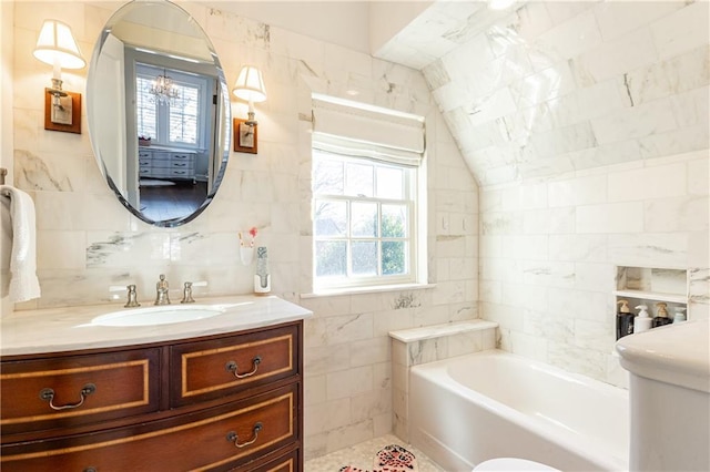 full bath with a bathing tub, a healthy amount of sunlight, tile walls, and lofted ceiling