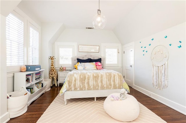 bedroom featuring dark wood finished floors, visible vents, and multiple windows