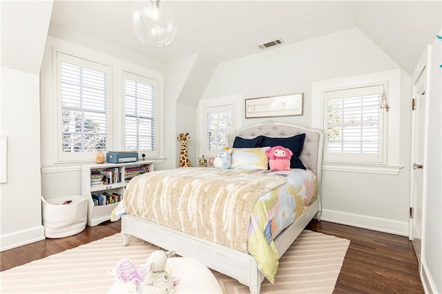 bedroom with multiple windows, dark wood-style floors, visible vents, and baseboards