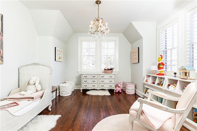 bedroom featuring baseboards, lofted ceiling, an inviting chandelier, and wood finished floors