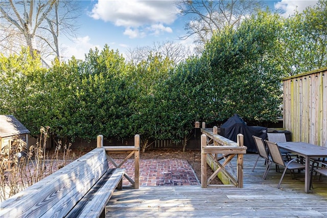 wooden deck featuring outdoor dining area and fence