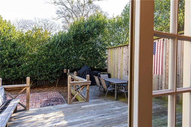 deck featuring outdoor dining space and fence