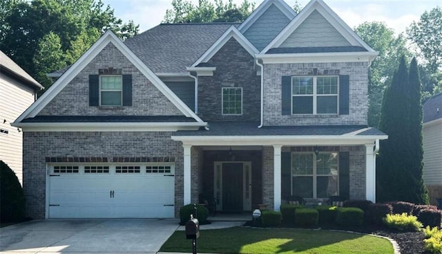 craftsman-style house featuring a porch, brick siding, driveway, and a front lawn