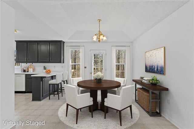 305 Bridgewater Ter, Canton, GA 30115 - dining room featuring a chandelier, plenty of natural light, a textured ceiling, and lofted ceiling