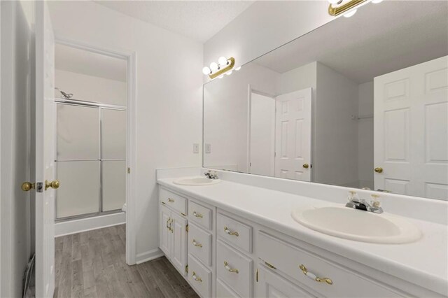 305 Bridgewater Ter, Canton, GA 30115 - full bathroom with double vanity, wood finished floors, and a stall shower