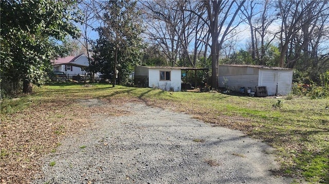 exterior space featuring a storage shed and a front yard