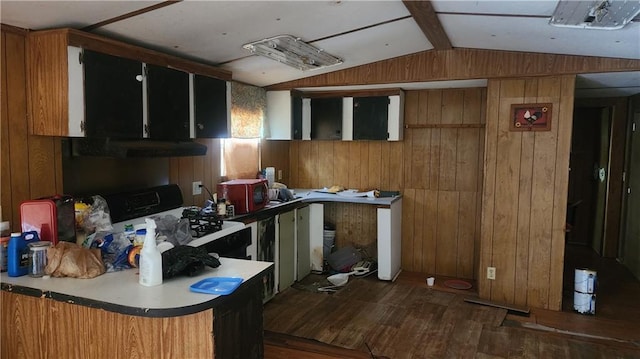 kitchen with dark wood-type flooring, wooden walls, black gas stove, and vaulted ceiling with beams