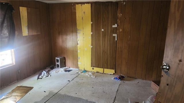 spare room featuring wooden walls