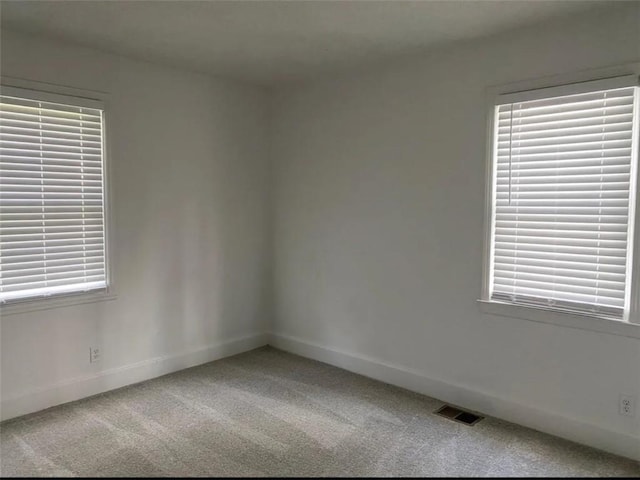 1380 Westmont Rd SW, Atlanta, GA 30311 - carpeted empty room featuring baseboards, a wealth of natural light, and visible vents