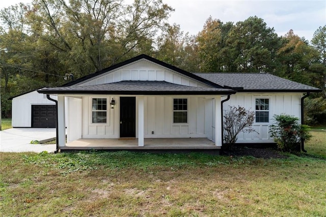 1912 Wax Rd, Aragon, GA 30113 - back of property featuring board and batten siding, a lawn, a garage, covered porch, and roof with shingles