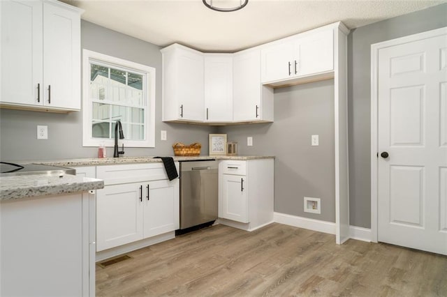 1912 Wax Rd, Aragon, GA 30113 - kitchen with stainless steel dishwasher, light wood-style floors, white cabinets, and light stone counters