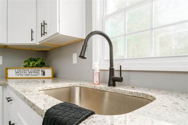 1912 Wax Rd, Aragon, GA 30113 - kitchen view of a sink, white cabinetry, and light stone counters