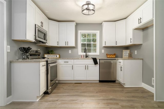1912 Wax Rd, Aragon, GA 30113 - kitchen featuring stainless steel appliances, a sink, white cabinets, and light stone countertops