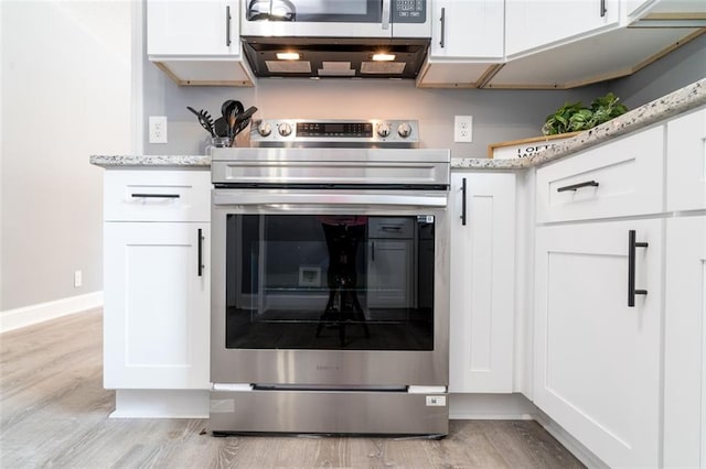 1912 Wax Rd, Aragon, GA 30113 - kitchen view of stainless steel appliances, light wood-style flooring, white cabinets, and light stone counters