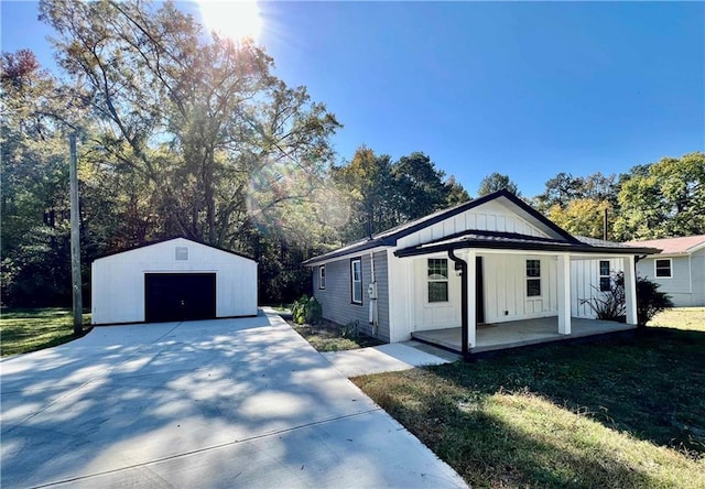 1912 Wax Rd, Aragon, GA 30113 - view of property exterior with board and batten siding, covered porch, an outdoor structure, a garage, and driveway