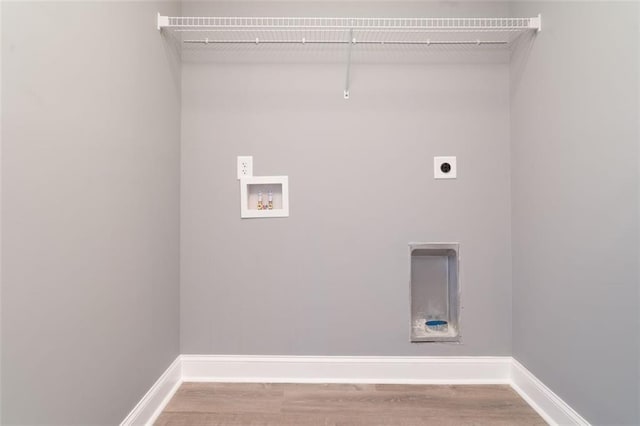 1912 Wax Rd, Aragon, GA 30113 - laundry area featuring electric dryer hookup, washer hookup, wood finished floors, and baseboards