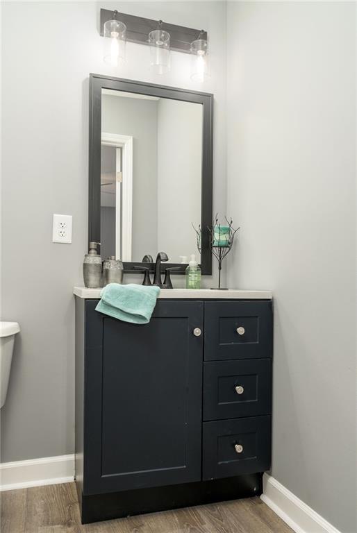 1912 Wax Rd, Aragon, GA 30113 - bathroom with wood finished floors, baseboards, and vanity