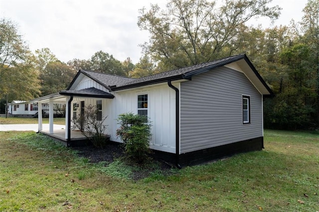 1912 Wax Rd, Aragon, GA 30113 - view of side of home featuring a lawn, board and batten siding, crawl space, and a carport