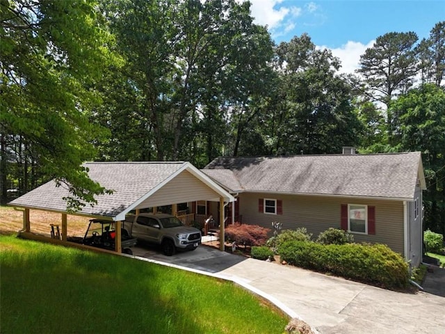 ranch-style home featuring a carport and a front lawn